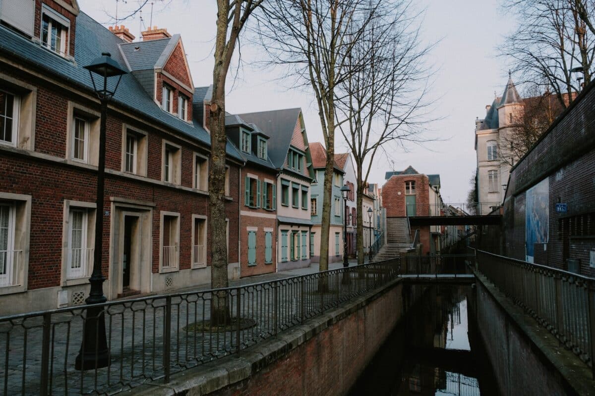 a canal running through a city next to tall buildings